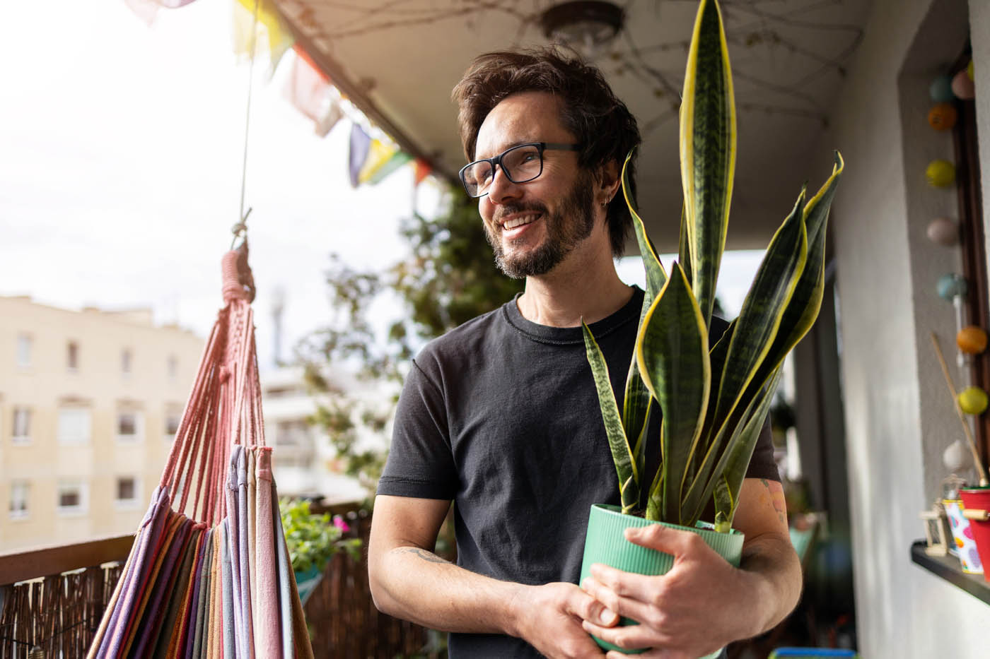 A man holding a plant - get a free estimate for your pest control service in Bayport, NY.