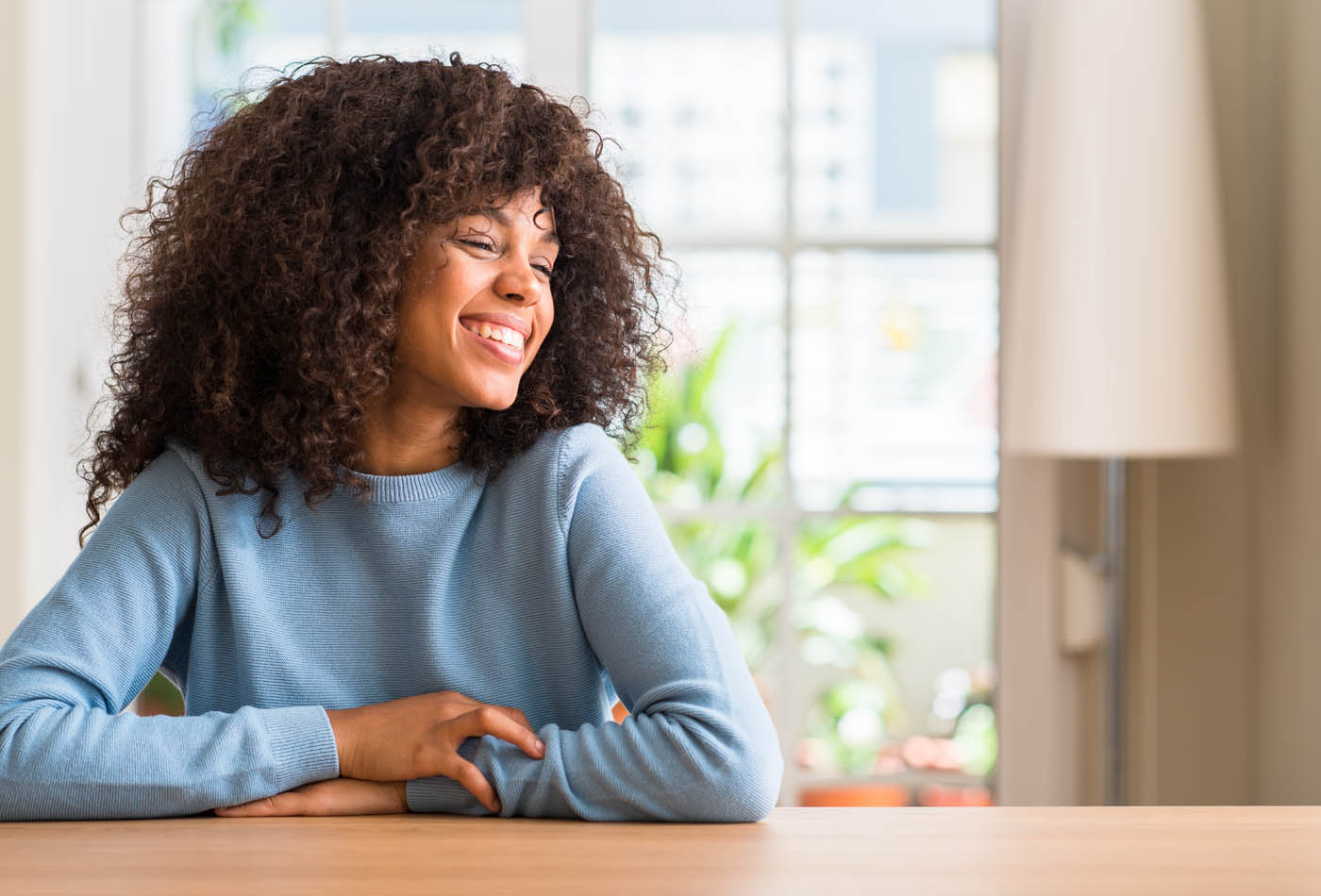 a woman sitting in her apartment.