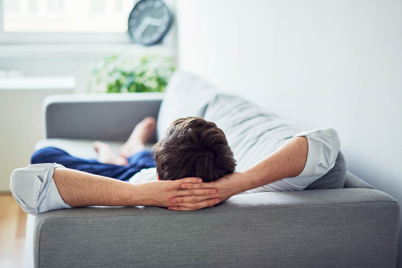 A man relaxing in his home, knowing termites are no longer a threat to his property - find this same peace of mind with Rest Easy Pest Control, the best termite company in Suffolk County, NY.