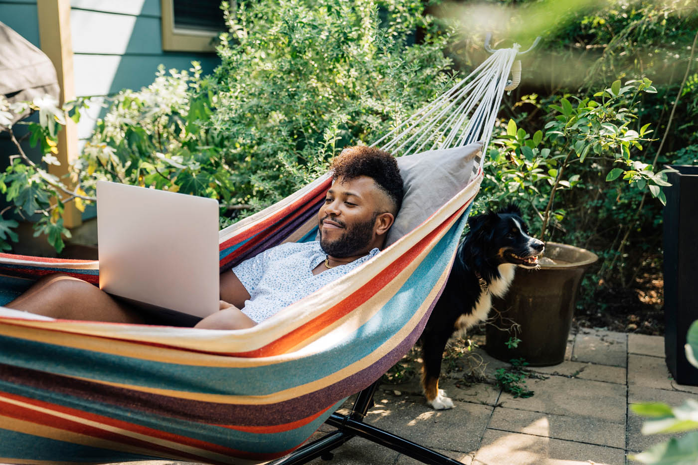 A man enjoying his pest-free backyard - Rest Easy Pest Control provides the best pest management services.